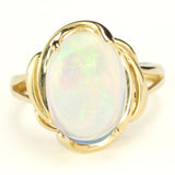White Ethiopian Opal that seems to contain Nebulae and Galaxies set in a Modern-Style Gold Ring