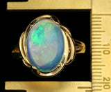 White Ethiopian Opal that seems to contain Nebulae and Galaxies set in a Modern-Style Gold Ring