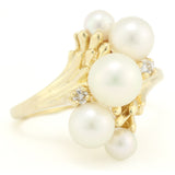 Gold Ring with Graduated Freshwater Pearls and Diamond Accents.