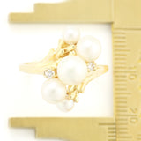 Gold Ring with Graduated Freshwater Pearls and Diamond Accents.