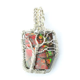 Ammolite Fossil set in a Silver Wire-Wrapped Pendant Under a Branching Tree