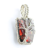 Ammolite Fossil set in a Silver Wire-Wrapped Pendant Under a Branching Tree