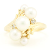 Gold Ring with Graduated Freshwater Pearls and Diamond Accents.