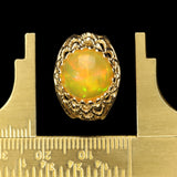 Large Ethiopian Honey Opal Cabochon with strong Orange and Green play-of-color in Gold Ring with Fancy Gallery Bezel
