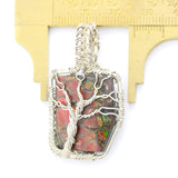Ammolite Fossil set in a Silver Wire-Wrapped Pendant Under a Branching Tree